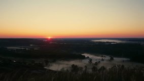 Foggy morning over plain, river floodplain meadow near rural village, landscape from birds eye view. Sunrise on summer morning over river, beautiful natural landscape. Sun is seen above horizon, sky - Powered by Shutterstock - Get 15% off with code: PIKWIZARD15