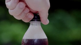 Watch an Unforgettable Moment as a Soda Bottle Erupts With Fizz During a Fun Outdoor Gathering - Powered by Shutterstock - Get 15% off with code: PIKWIZARD15