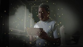 Senior man using tablet in bedroom, with glowing particles floating around showing technology theme. Elderly, relaxation, wellness, peaceful, ambient, digital, comfort - Powered by Shutterstock - Get 15% off with code: PIKWIZARD15