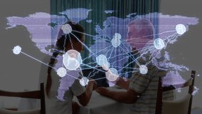 Senior man and caregiver exploring digital communication via tablet at dining table with map icons. Technology, communication, connectivity, digital, intergenerational, innovation, home - Powered by Shutterstock - Get 15% off with code: PIKWIZARD15