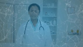 Female doctor standing arms folded in clinic, showing health network mesh and floating crypto icons. Clinical, technology, innovation, healthcare, digital, finance, professional - Powered by Shutterstock - Get 15% off with code: PIKWIZARD15