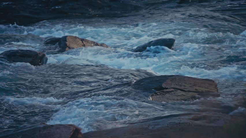 Fast Flowing River On Smooth Rocks In Kokelv, Norway. Close-up Shot