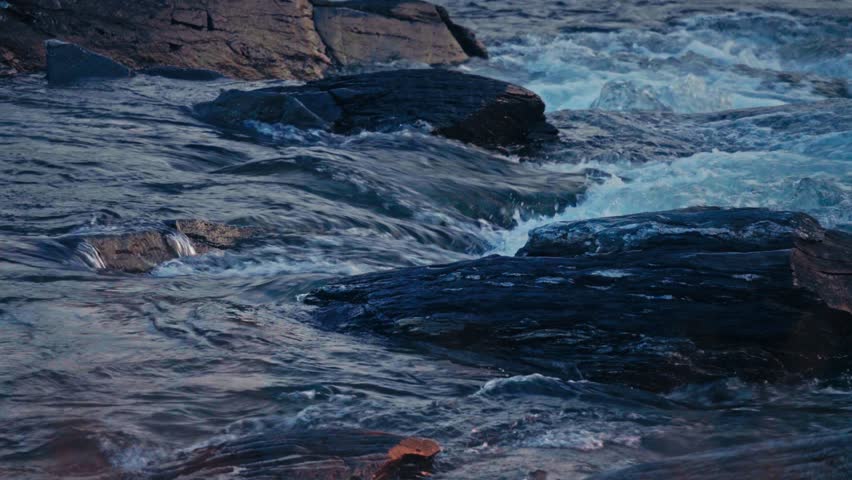 Flowing Stream Over Mossy Rocks Near Kokelv Village In Norway. Close-up Shot