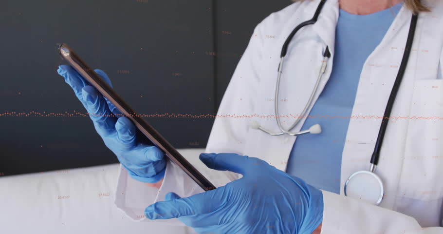 Doctor wearing lab coat tapping tablet in medical office, displaying animated patient data icons. Medical, healthcare, professional, technology, diagnostic, modern, clinical