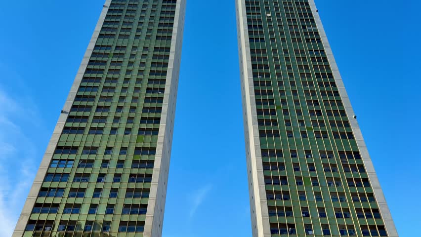 A stunning view featuring two impressive modern twin towers beautifully set against a bright blue sky