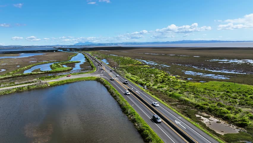 Panoramic drone shot of cars on the delta highway 37, in sunny California, USA
