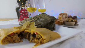 Traditional Christmas dinner with hallacas, pan de jamón, olives, and festive lights - Powered by Shutterstock - Get 15% off with code: PIKWIZARD15