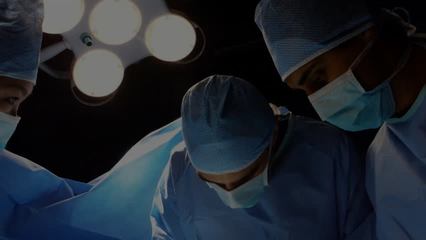 Surgical team performing surgery in operating room, displaying green digital network overlay. Medical team, healthcare, innovation, high-tech, precision, teamwork, clinical - Powered by Shutterstock - Get 15% off with code: PIKWIZARD15