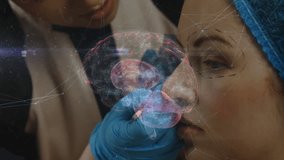 Female doctor holding patient head with gloved hand in clinic, projecting holographic brain overlay. Medical, technology, innovation, healthcare, diagnostic, futuristic, digital - Powered by Shutterstock - Get 15% off with code: PIKWIZARD15