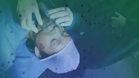 Medical professional adjusting oxygen mask over patient on surgical drape with health data overlay. Healthcare, surgery, medical, hospital, anesthesia, clinical, technology - Powered by Shutterstock - Get 15% off with code: PIKWIZARD15