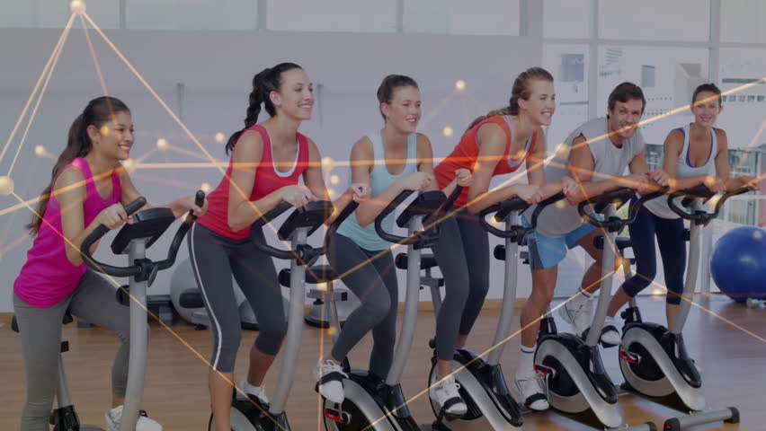 Six adults pedaling stationary bikes in fitness studio, glowing network lines showing health data. Exercise, wellness, vibrant, teamwork, motivation, urban, fitness - Powered by Shutterstock - Get 15% off with code: PIKWIZARD15
