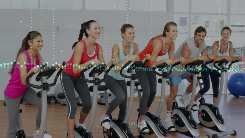 Group cycling on stationary bikes in fitness studio, displaying animated data points and overlays. Cardio, workout, athletic, vibrant, teamwork, determination, urban - Powered by Shutterstock - Get 15% off with code: PIKWIZARD15