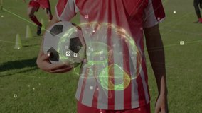 Teenage boy holding soccer ball on field with cones, with 3D brain overlay showing technology data. Athlete, sports, training, futuristic, innovation, technology, outdoor - Powered by Shutterstock - Get 15% off with code: PIKWIZARD15