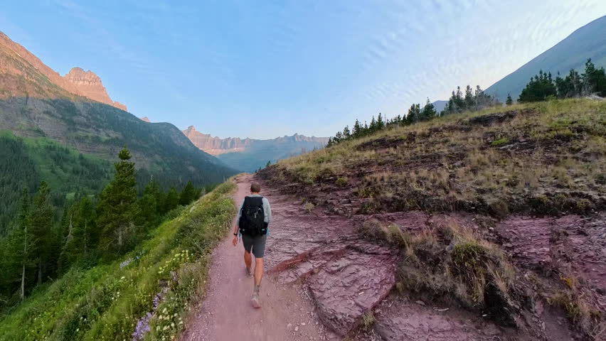 Following Man Hiking Toward Iceberg Lake in Glacier National Park