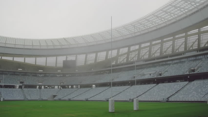 Open-air stadium being animated with floating UI labels moving across goal posts and green field. Stadium, sports, data visualization, technology, digital interface, outdoor, architecture