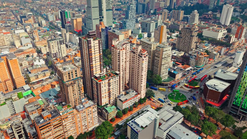 Fly over residential buildings in the Las Aguas neighborhood in downtown Bogota, Colombia on a sunny day, public transportation service, Transmilenio.