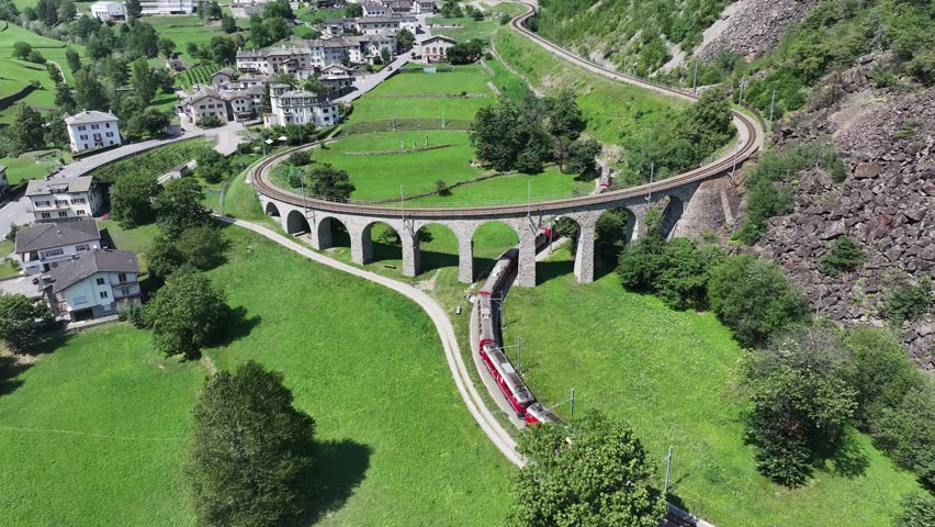 Train on the Iconic Brusio Spiral Viaduct in the Swiss Alps