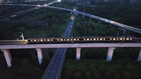 Explore aerial views of intercity light rail trains traveling through urban landscapes at night - Powered by Shutterstock - Get 15% off with code: PIKWIZARD15