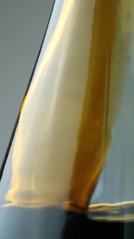 Soy Sauce Pouring Into Glass Bottle Vertical Slow Motion.