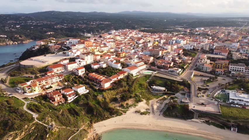 A pull-back aerial footage of the town of Santa Teresa Gallura, Sassari, Sardinia island, Italy on a sunny day