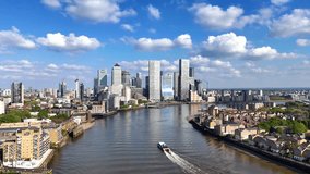 Aerial view of the financial district Canary Wharf and the Docklands in London, England, during a sunny day - Powered by Shutterstock - Get 15% off with code: PIKWIZARD15
