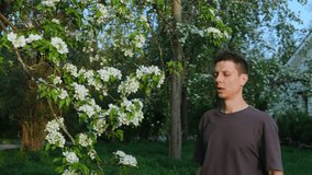 Young Man Sneezing Outdoors Due to Seasonal Allergy. Sick Male Suffering from Pollen Allergy in Spring Park and Using White Napkins - Powered by Shutterstock - Get 15% off with code: PIKWIZARD15