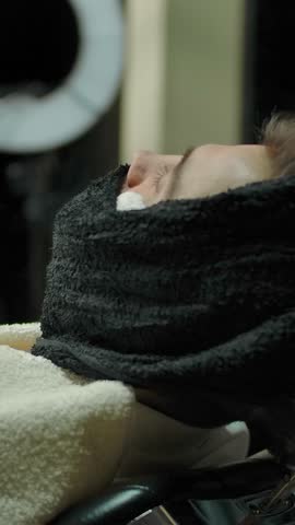 Woman barber wraps customer