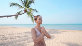Concentrated calm young yoga woman with closed eyes and praying hands meditating on sandy beach by seashore, stress relief and mindfulness, healthy mind  - Powered by Shutterstock - Get 15% off with code: PIKWIZARD15