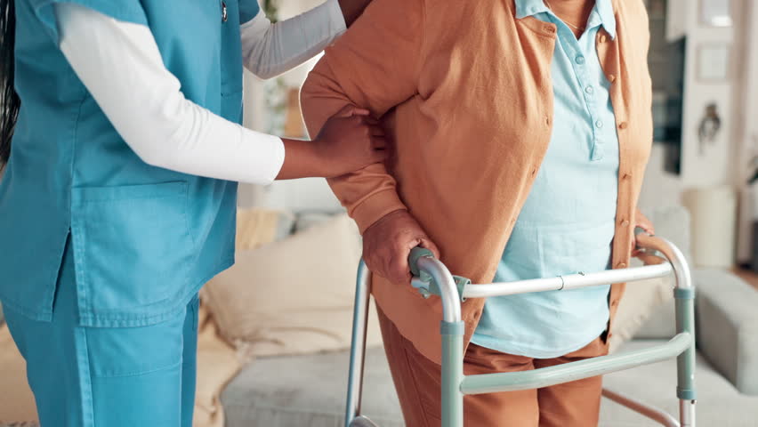 Hands, nurse and old woman with walker in nursing home for mobility support, helping hand and rehabilitation. Retirement, caregiver and senior person with walking guidance for recovery and healing