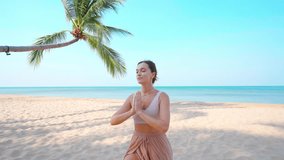 Concentrated calm young yoga woman with closed eyes and praying hands focus on meditating on sandy beach by seashore, stress relief and mindfulness, wellness  - Powered by Shutterstock - Get 15% off with code: PIKWIZARD15