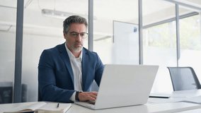 Focused senior businessman entrepreneur sitting at desk working on financial project, looking thinking at screen. Mature 50s Latin business man ceo manager using laptop computer in office. Copy space - Powered by Shutterstock - Get 15% off with code: PIKWIZARD15