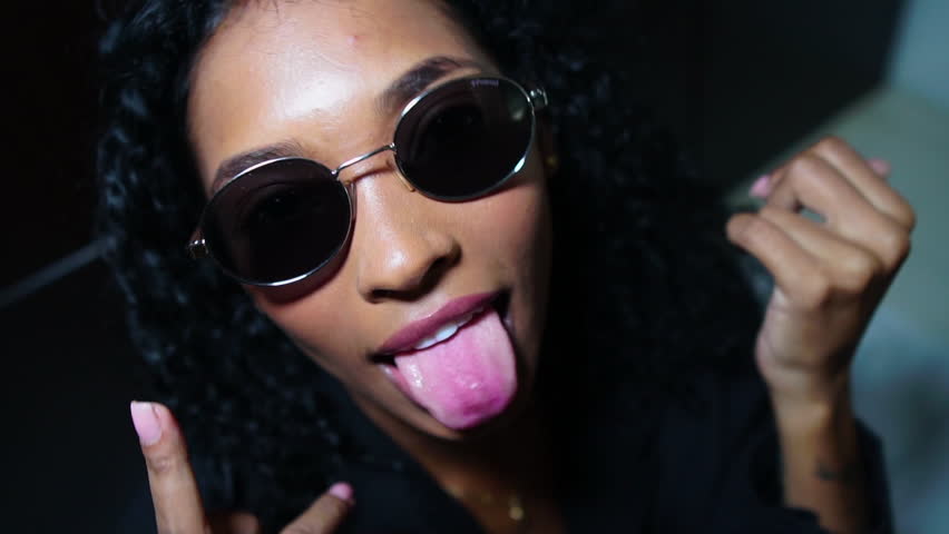 Sexy Provocative Women in Black Shirt Showing Middle Finger and Stick Out Tongue