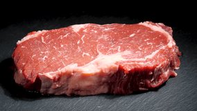 Steak Meat Rotating Background. Raw Beef Ribeye Close Up Video Backdrop. Food Concept. Ready to Grill Meat - Powered by Shutterstock - Get 15% off with code: PIKWIZARD15
