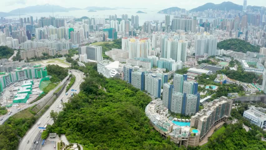 Aerial View of Hong Kong Cityscape with Lush Green Hillside