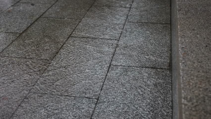 4K Video of Rain Droplets Cascading from Eaves