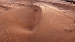 Natural sand dunes forming abstract wave shapes and warm colors during sunrise over the Vietnamese landscape. Shadow and light drone fly over. - Powered by Shutterstock - Get 15% off with code: PIKWIZARD15