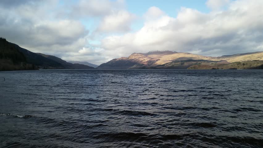 Fast and low aerial drone flyover of the beautiful waters of Loch Lomond - Scotland, UK