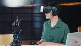 Teenager wearing VR glasses explores a robot arm project in a classroom. Engaging in robotics programming combining technology STEM education and futuristic innovation. moves a robotic hand - Powered by Shutterstock - Get 15% off with code: PIKWIZARD15