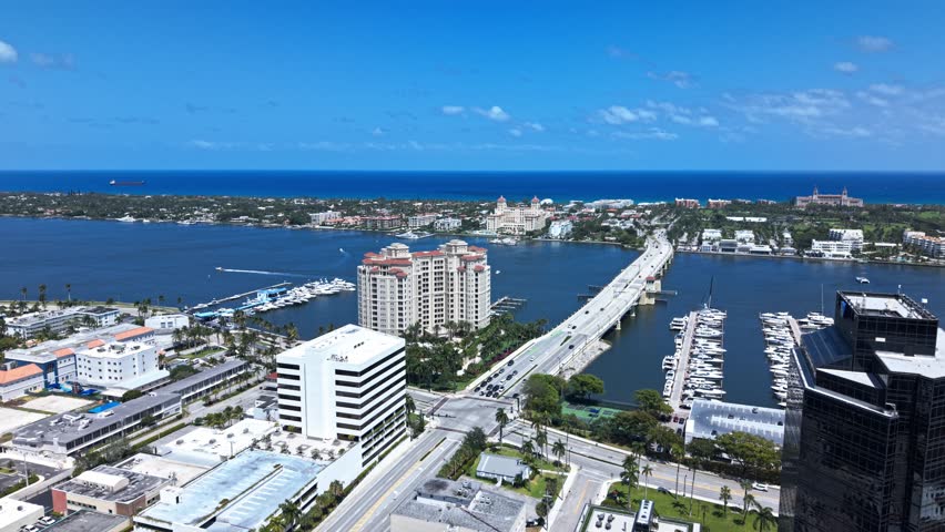 Aerial: West Palm Beach cityscape, harbor, pier, yachts and marina during the day in Florida, USA, push in drone shot