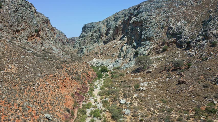 Drone flying through the rugged Zakros Gorge, a popular hiking spot in Crete