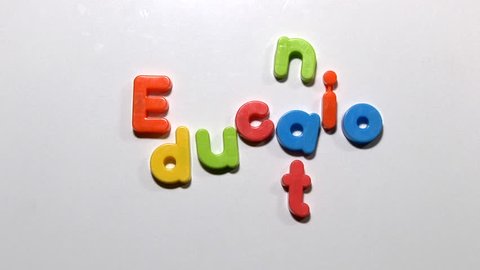 Stop motion animation of fridge magnets moving to spell the word education