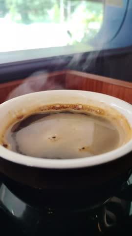 Close-up steaming hot coffee or tea cup