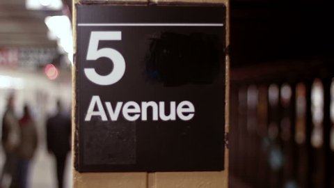 DOLLY: 5th Avenue Subway, NYC - a dolly shot revealing a subway train arriving at the 5th Avenue subway station