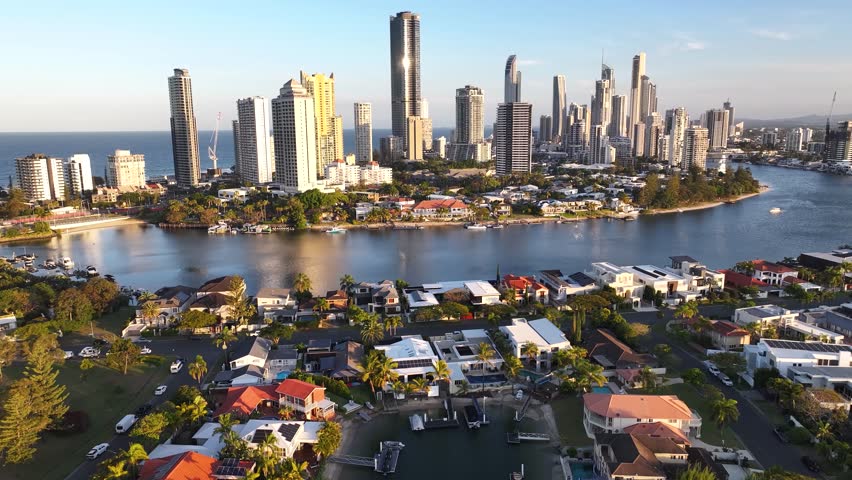 Drone flying over residential area to the city downtown, urban scenery of Gold Coast, Australia.