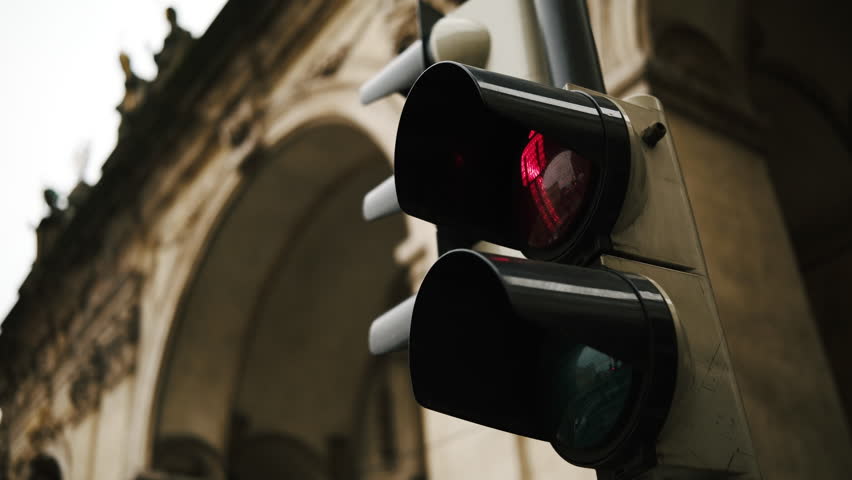 Red Traffic Light For Pedestrians On The Street Switches To Green