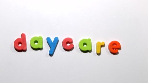 Stop motion animation of fridge magnets moving to spell the word daycare