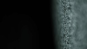 Close-up angled view of television static noise pattern transitioning as the screen fades to black from the left, leaving a vertical band of flickering interference texture on the right side display. - Powered by Shutterstock - Get 15% off with code: PIKWIZARD15
