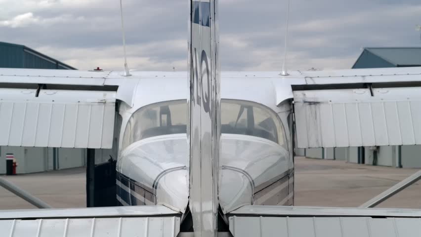 Flight Instructor Checks Rudder of Airplane during External Prelfight - Powered by Shutterstock - Get 15% off with code: PIKWIZARD15