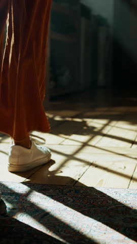 Walking, house and person with shoes, fashion or sneakers on wooden floor for back view. Ground, legs and feet with steps to travel on oak planks in home living room with cool footwear for journey