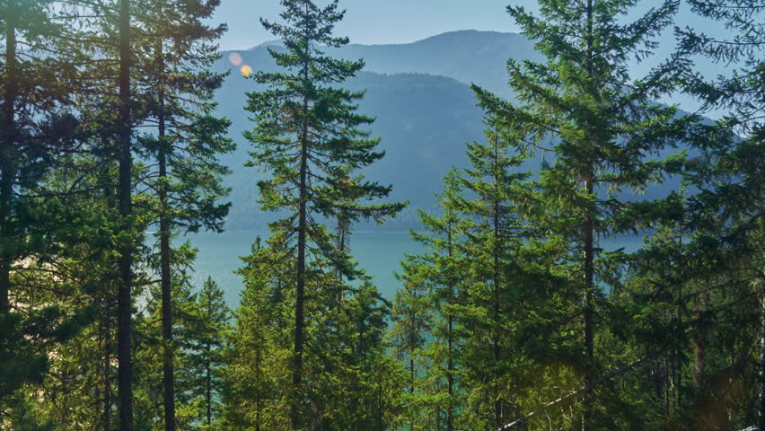 Sun sets behind North Cascades at Ross Lake in Washington State, timelapse